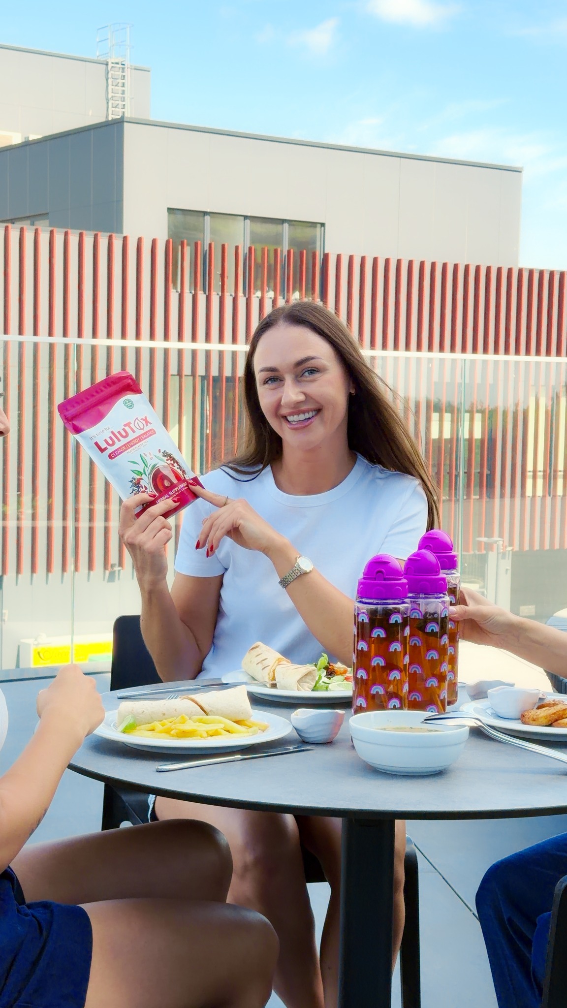 Lulutox customer holding the pouch at an outdoor lunch